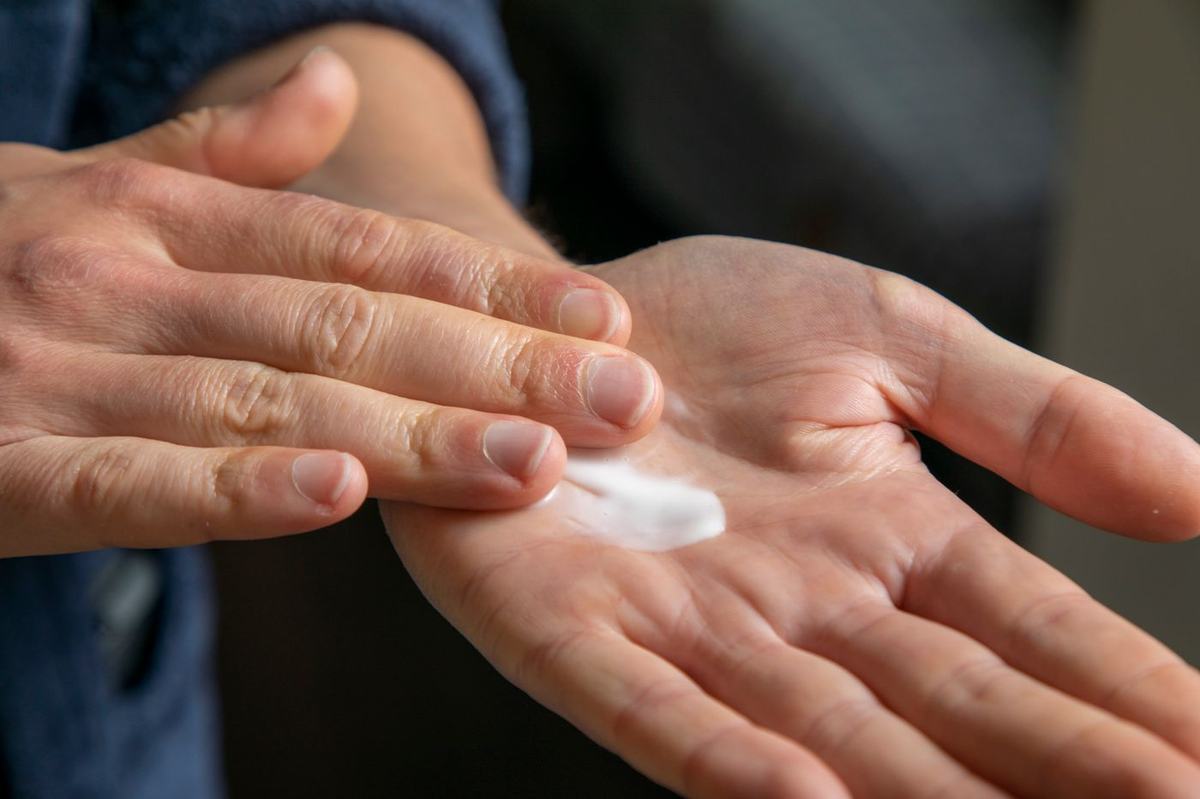Dermatologist examining a patient's arm