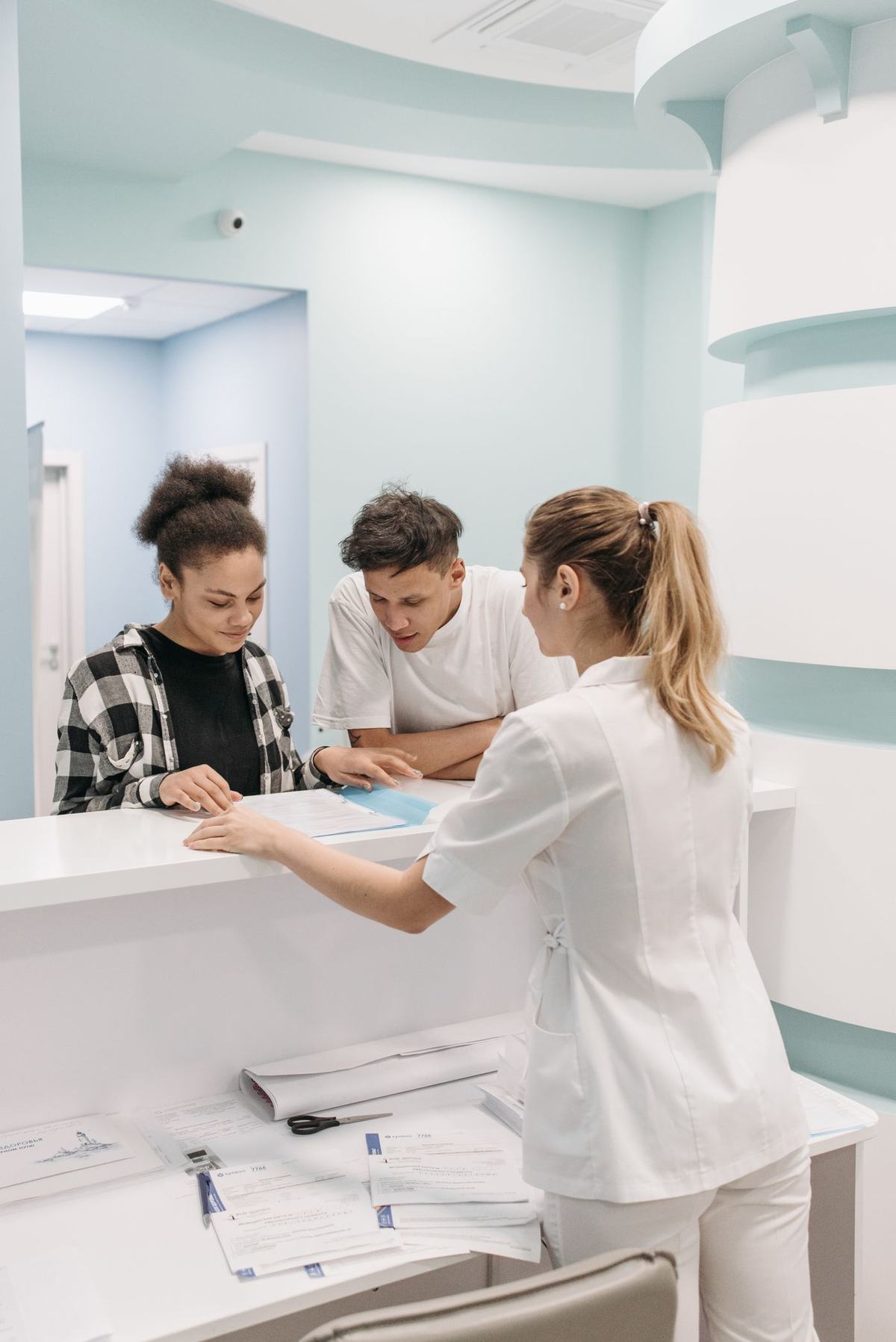 Dermatologist speaking with a patient in a consultation room